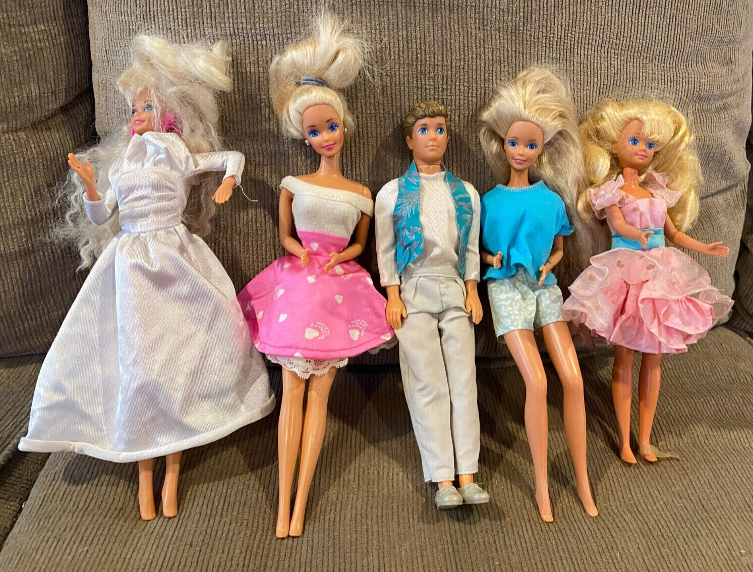 Four Barbie and One Ken Doll