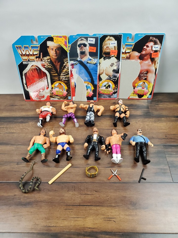 A legit WWF Hasbro figure + accessories lot spanning Jake the Snake to Snuka — a nostalgia hit for anyone who grew up in the golden era of wrestling.
