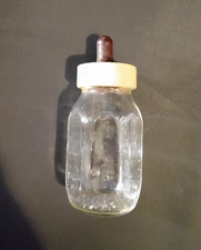 EVENFLO GLASS BABY BOTTLE, 1960. 4", 120 cc,  w ORIGINAL NIPPLE.