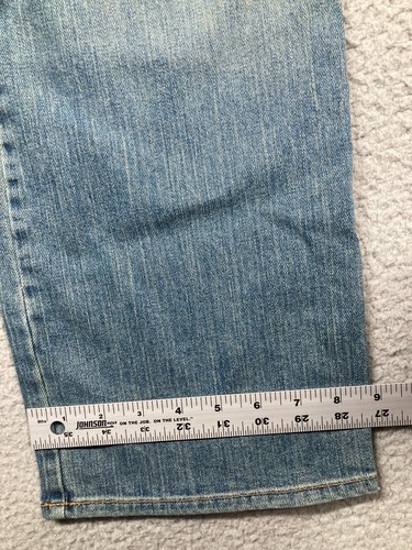 Blue stretch light wash Karen Kane women’s jeans with 6, 7, and 8 leg measurements, USA made, on a gray surface.