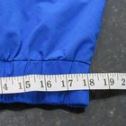 Blue vintage 90s Polo Sport Ralph Lauren jacket with white cuff, shown beside a measuring tape in inches.