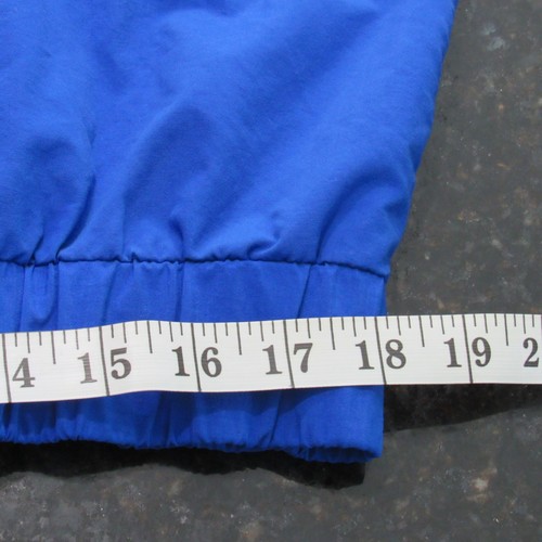 Blue vintage 90s Polo Sport Ralph Lauren jacket with white cuff, shown beside a measuring tape in inches.