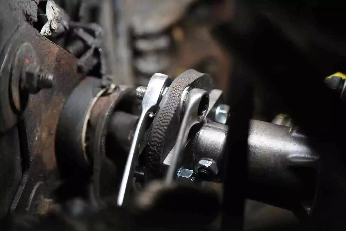 A close-up view of the rag joint on a vintage car’s steering column shaft.