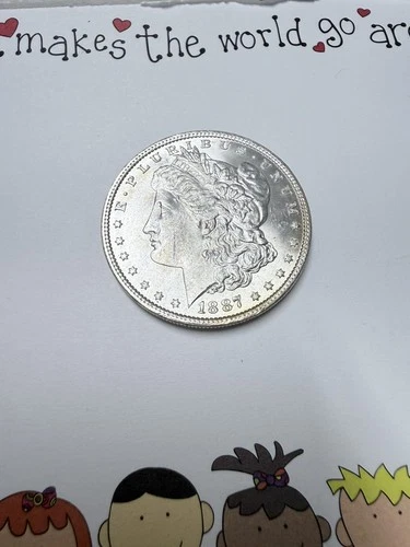 1887 Morgan silver dollar uncirculated and some toning