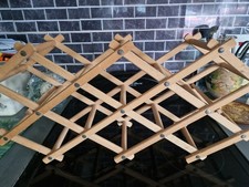 Simple wooden wine rack folds flat holds at least 8 bottles