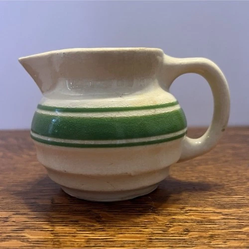 Hull Beehive Yellowware green striped small ball pitcher.