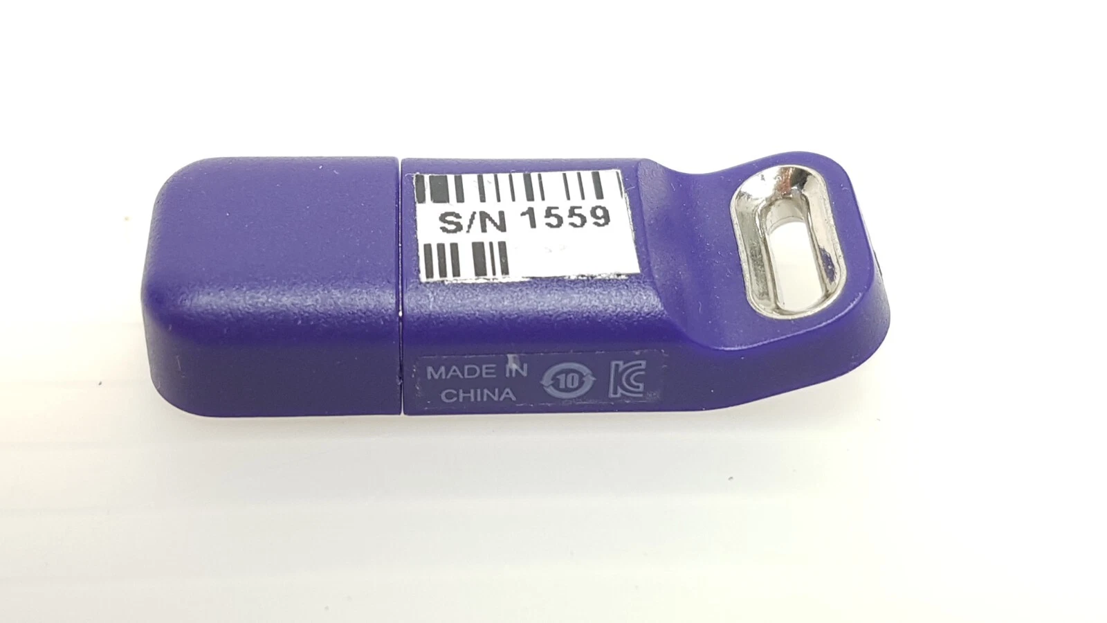 Reverse side of the LightSheer Desire UG-1171030-D key with barcode label and KC mark