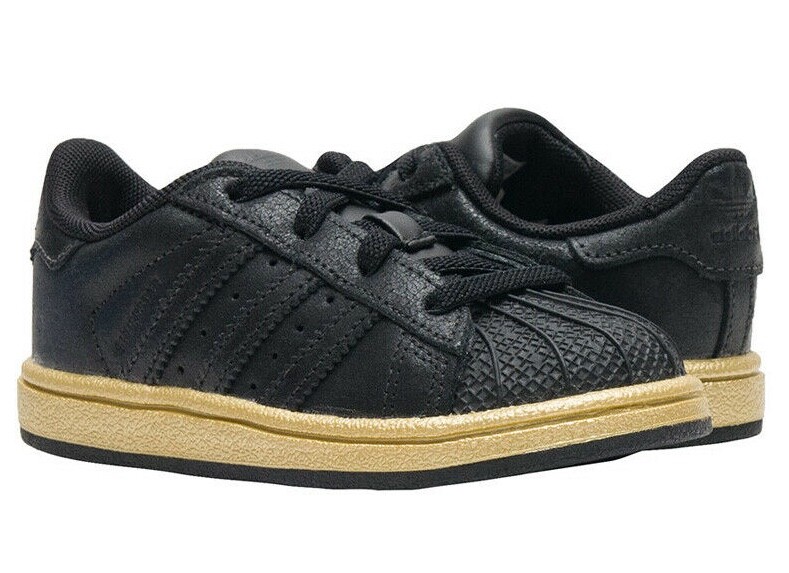 black adidas with gold sole