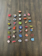 College NCAA Teams  Croc Charms Jibbitz Style  Plug – $1.99 Each Select Teams.