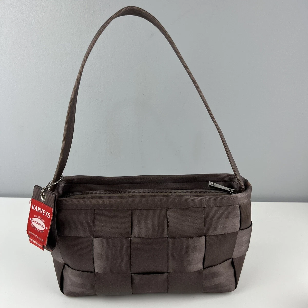 Seatbelt handbags top