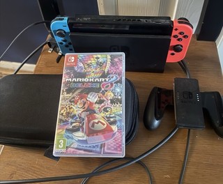 Nintendo Switch Console Bundle includes Mario Kart 4 games.