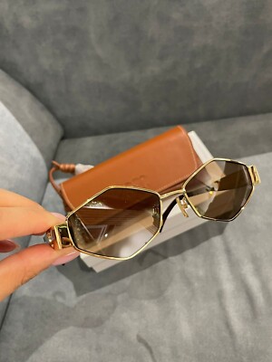 Céline women's sunglasses with a metallic golden frame and oval 