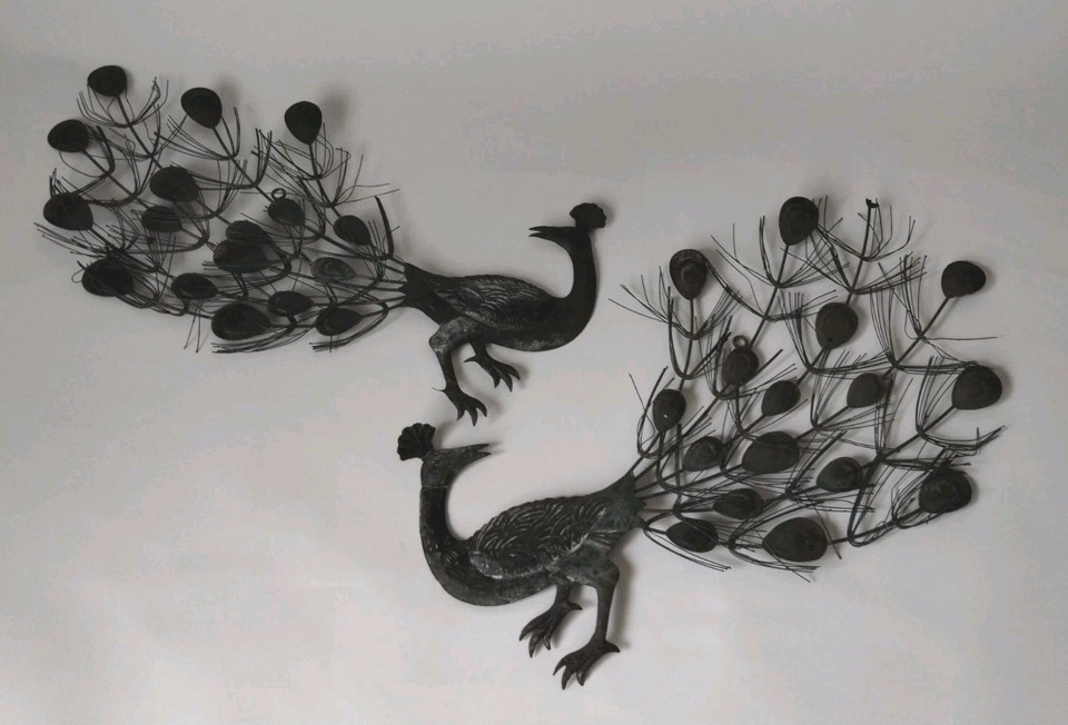 A vintage metal peacock wall hanging — bold, graphic, and unmistakably MCM in the best possible way.