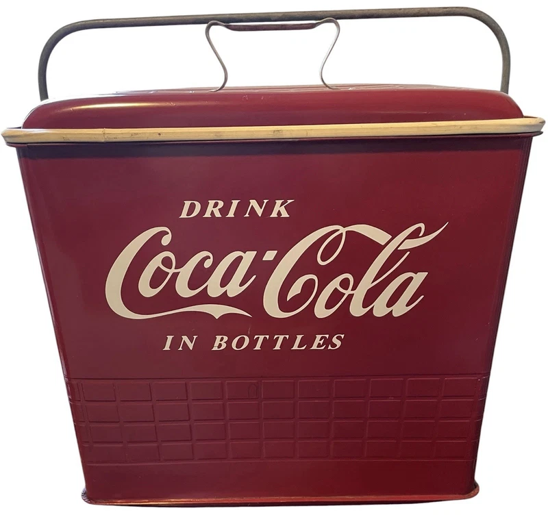 Coca-Cola metal cooler with a built-in bottle opener and a bottom drain