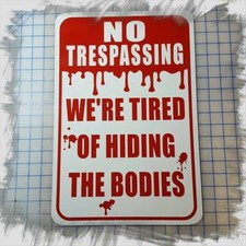 NO TRESPASSING WE'RE TIRED OF HIDING THE BODIES 12"x18" METAL SIGN