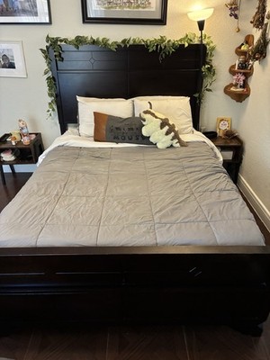 Dark wood queen bed frame with storage space, headboard, footboard and boxspring