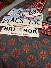 Arkansas  license plate with RANDOM Number LETTER ( Sold As Is)