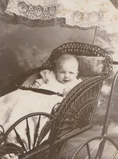 SMILING BABY IN ORNATE BABY BUGGY WITH UMBRELLA. CABINET CARD. 
