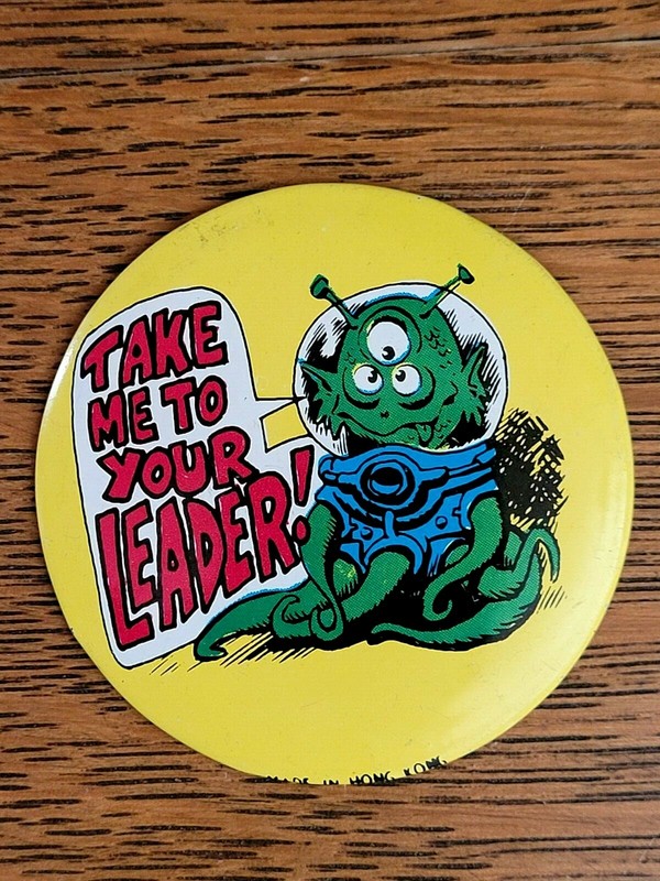 1970'S "TAKE ME TO YOUR LEADER" 3-EYED MONSTER PINBACK BUTTON