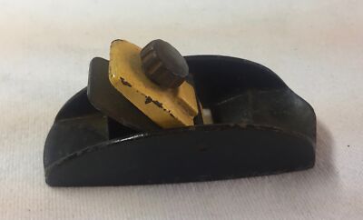 vintage metal plane ~ 1 inch wide aperture, 3 and 5/8 inches long