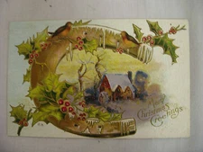 VINTAGE EMBOSSED CHRISTMAS POSTCARD HOLLY COVERED HORSESHOE W/ VILLAGE UNUSED