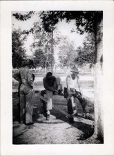 WW2 Photo of Soldiers Resting on Bench Under Trees at Camp