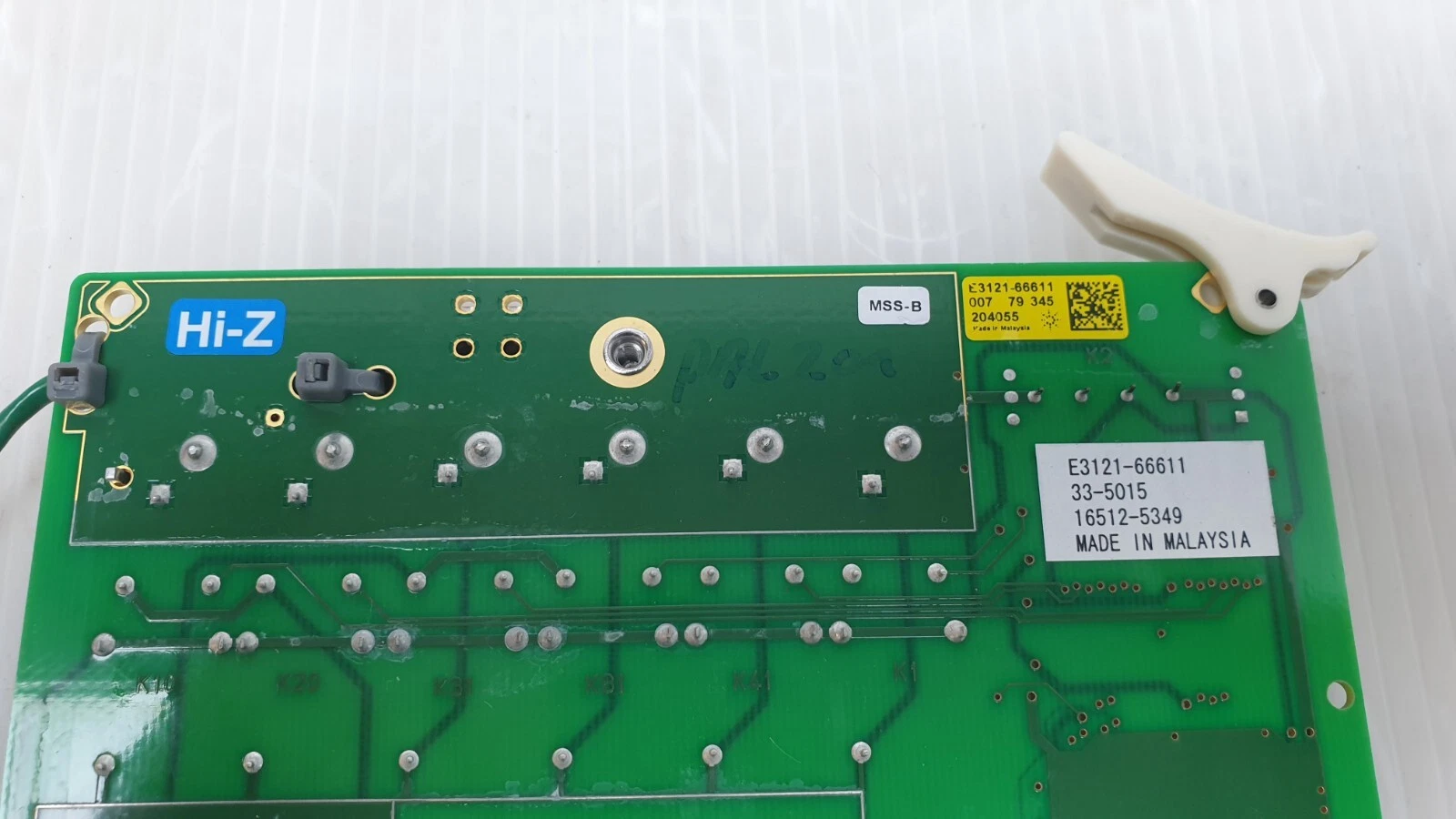 Hi-Z section, MSS-B tag and yellow Agilent E3121-66611 label on the board back
