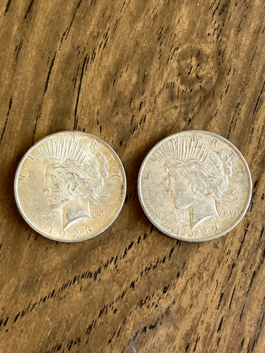 Two [2] - - Peace Silver Dollars - - 1922 and 1923 -- Very Good Condition