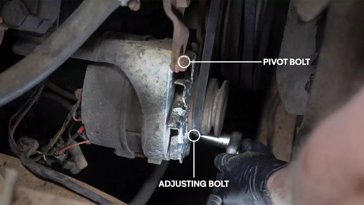 Releasing adjusting bolt to remove a V-belt.