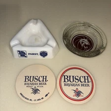 Two vintage ashtrays with bar coasters