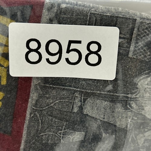 White label with black text “8958” and “Cropped Cavern Club Liverpool USA Made,” on worn grey fabric.