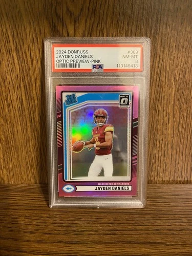 1 JAYDEN DANIELS 2024 PANINI DONRUSS OPTIC PREVIEW-PINK #389 ROOKIE RC PSA 8