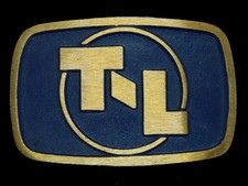 UE01131 NOS VINTAGE 1970s  T-L  ADVERTISEMENT SOLID BRASS BELT BUCKLE