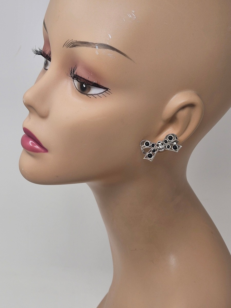 Chanel Silver tone Interlocking CC Logo crystal bow stud