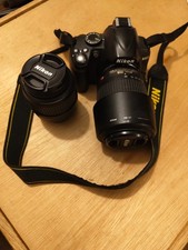 nikon d3000 camera with two lenses