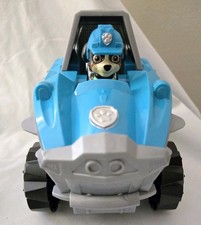 PAW Patrol Dino Rescue Deluxe Transforming Rev Up Vehicle Dex Wheelchair Figure