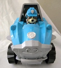 PAW Patrol Dino Rescue Deluxe Transforming Rev Up Vehicle Dex Wheelchair Figure