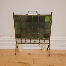 Antique brass fire screen with green glass panels