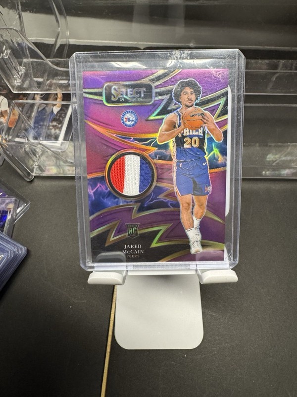 2024-25 Panini Select Rookie Patch Jared McCain Purple Tie Dye /99 (RC)