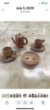 This is a miniature hand-painted wooden tea set.