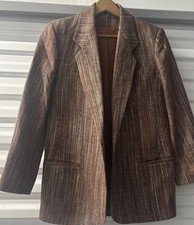 Blazer is labeled pure silk. No other info. See photos