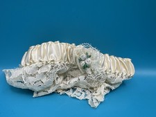 Vintage handmade ivory lace and satin wedding garter with a floral and bead