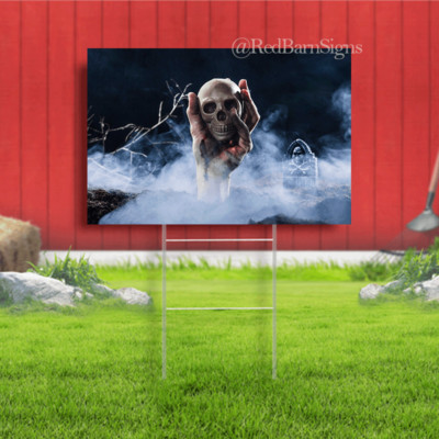 Hand sticking out of ground and holding skull halloween yard sign
