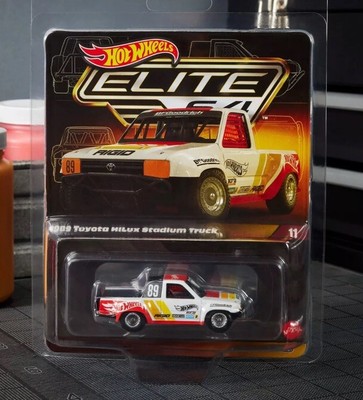 2024 HOT WHEELS ELITE 64: 1989 TOYOTA HILUX STADIUM TRUCK-PRESALE