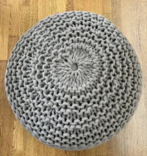 Grey knitted round pouf ottoman