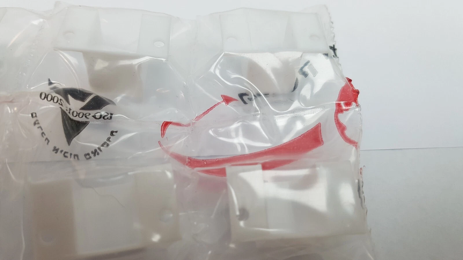 Sealed bag of white MM3736060 anode covers with supplier ISO 9001 print