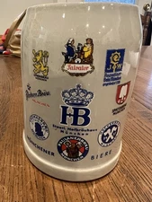 German beer stein featuring logos from various Munich breweries.  0.5 Liters