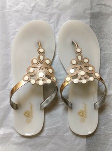 white and gold flip flops