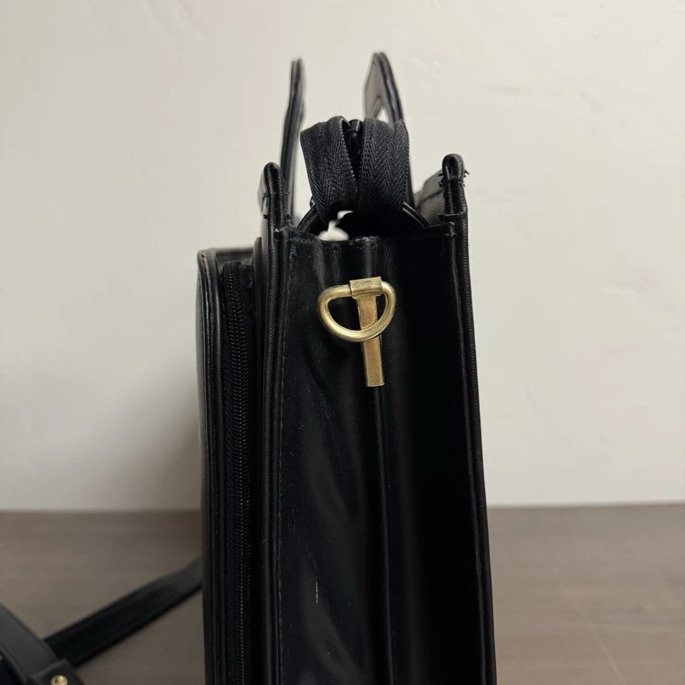 Maletín vintage de cuero negro con asas retráctiles estructurado para oficina Foto 3 de 4