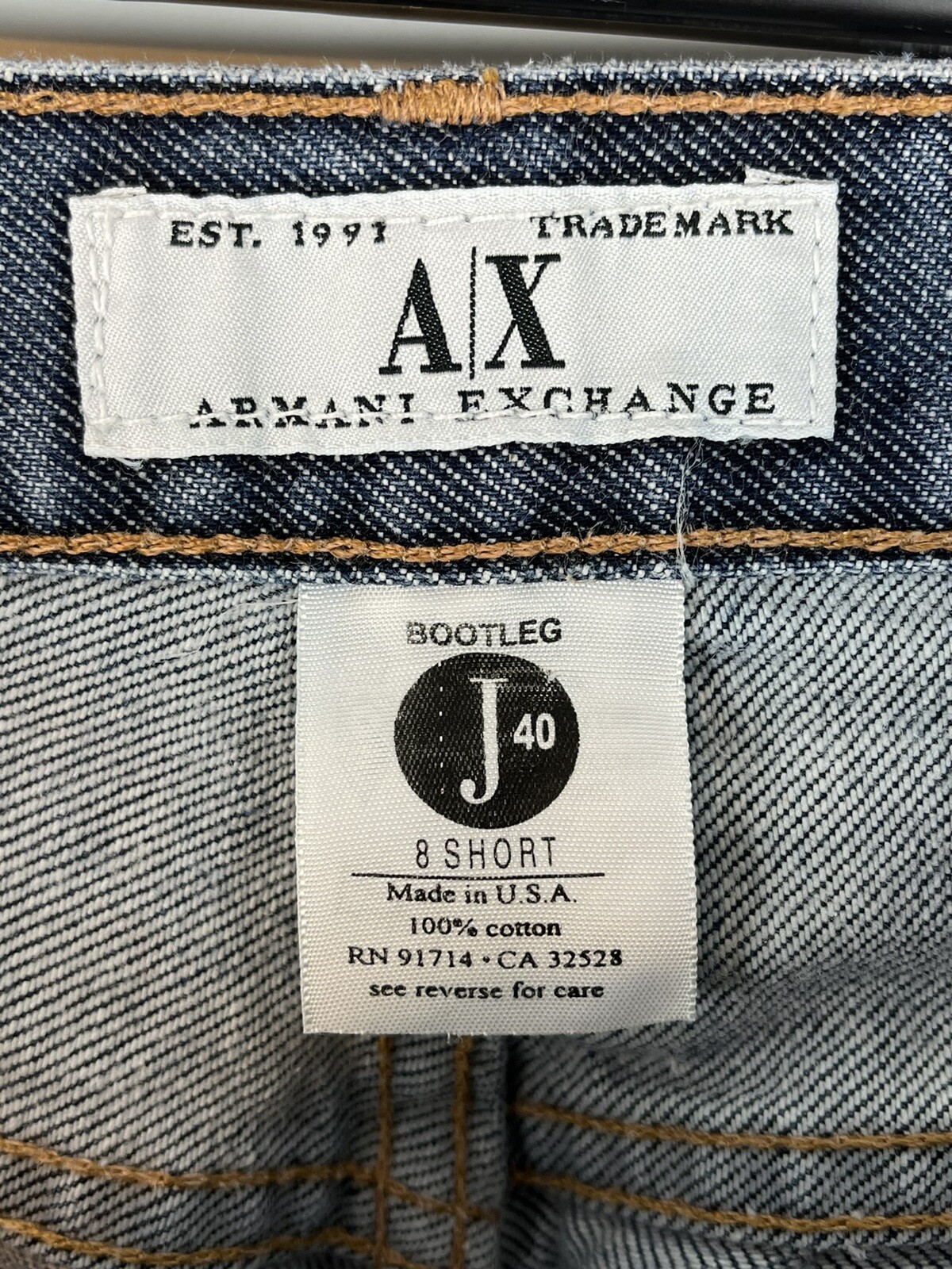 AX Armani Exchange J40 women’s size 8 short regular bootleg jeans with faded blue denim and white label reading “Made in U.S.A.”